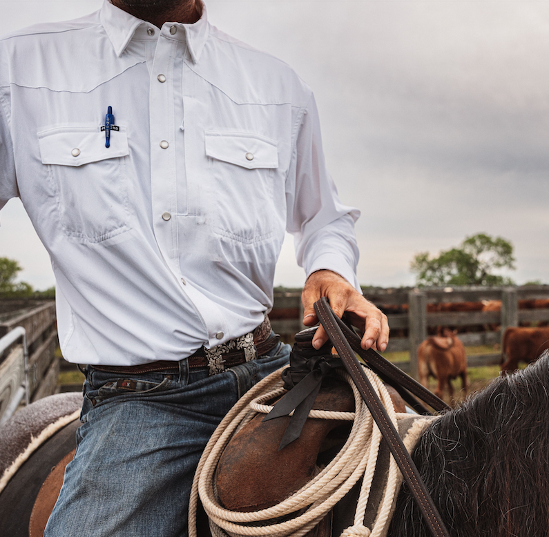 Man rides horse in great white shirt