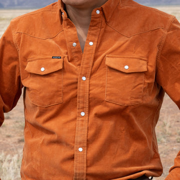 Man wearing orange corduroy outside