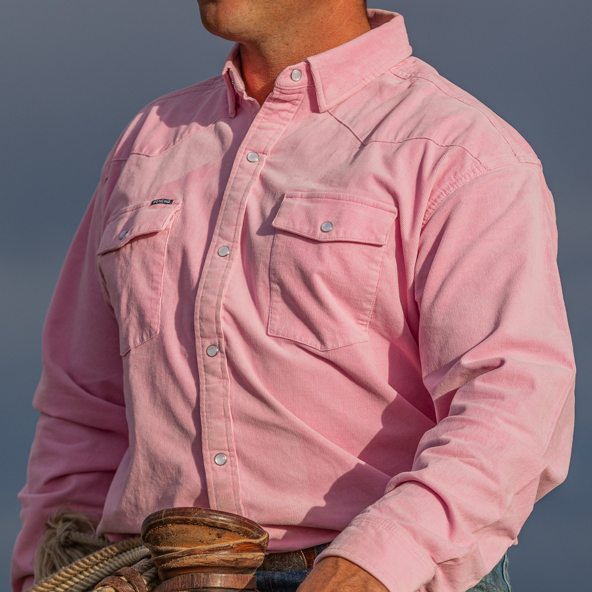 Cowboy on horse in a pink corduroy shirt