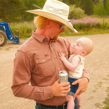 Man holding baby in red denim