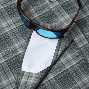 closeup of sunglasses with lens cleaner on shirt
