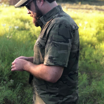 man wearing short sleeve camo shirt