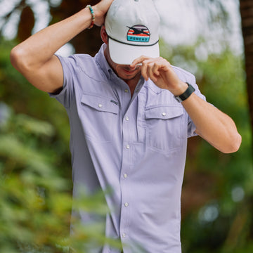 man wearing short sleeve light purple shirt