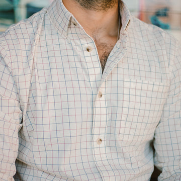 Close up of man wearing blue and red plaid button down shirt