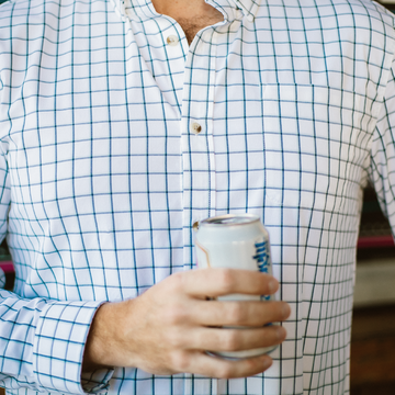 Close up photo of man wearing blue plaid button down shirt