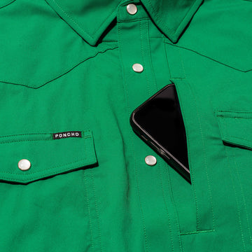 closeup of phone going into green shirt pocket