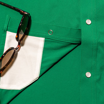 closeup of sunglasses cleaner of green shirt