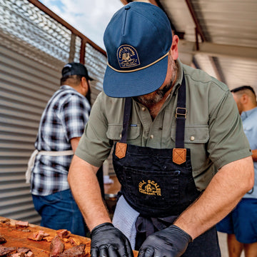 Man cooking BBQ in armadillo rope hat
