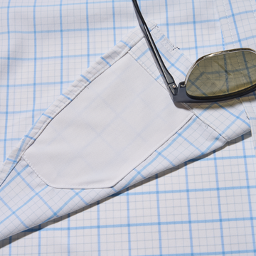 closeup of sunglasses and lens cleaner on shirt