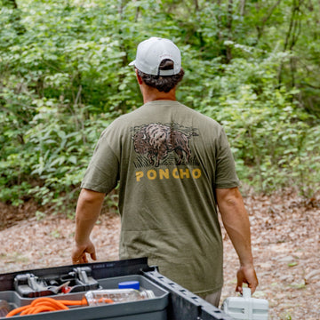 Back of bison t-shirt and man carrying turtlebox