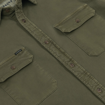 Close-up of the buttoned front and chest pockets on The Buck Snort outdoors shirt in olive green fabric.