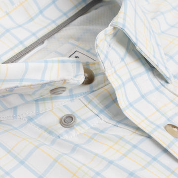 Close up of buttons on blue and yellow plaid shirt