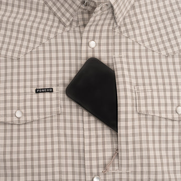 Phone in pocket of brown plaid pearl snap