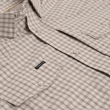 Close up photo of brown plaid pearl snap buttons