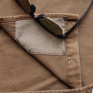 Detail shot of lens cloth on brow denim shirt