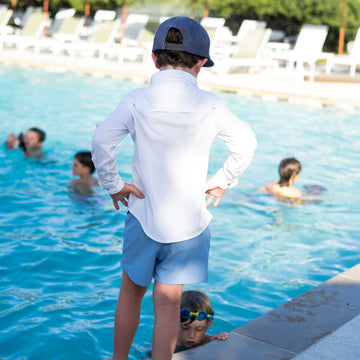 Kid at pool in white shirt