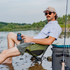 man sitting in chair on river in blue microcheck shirt