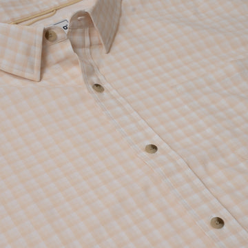 Close up photos of button down peach plaid shirt