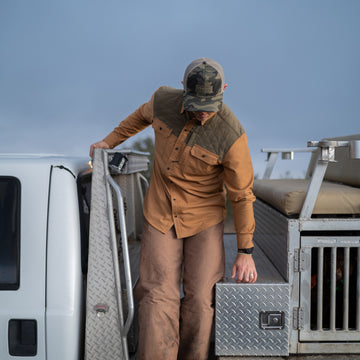 man getting off truck in brown and green shirt