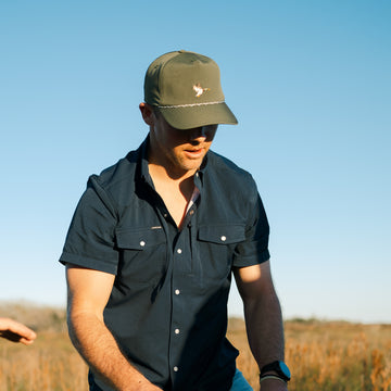 man wearing short sleeve navy shirt