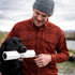 man training dog in red plaid flannel