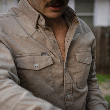 Detail shot of man wearing grey corduroy shirt outside