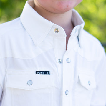 Detail shot of white pearlsnap kid's shirt