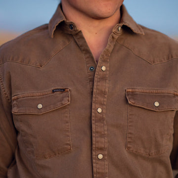 detail shot of man wearing brown denim shirt