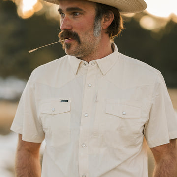 man wearing short sleeve tan shirt