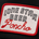 A rectangular embroidered patch with a red border featuring the text "Lone Star Beer Poncho" in black and red thread.