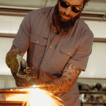 Man working in grey button down work shirts