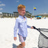 Kid holding net on beach in a long sleeve blue microcheck kid's shirt