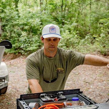 man grabbing tackle from truck bed