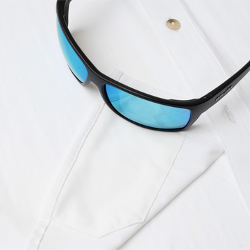 sunglasses with lens cleaner on white shirt