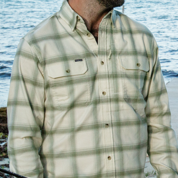 man with water wearing green and white plaid flannel