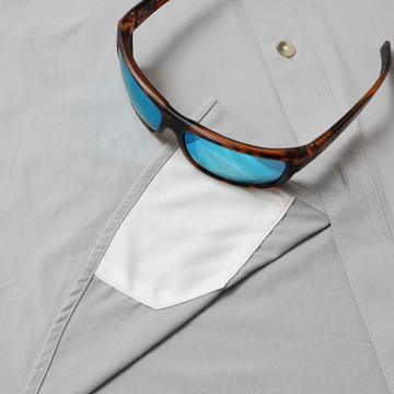 sunglasses with lens cleaner on shirt