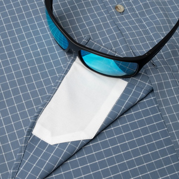 sunglasses with lens cleaner on shirt