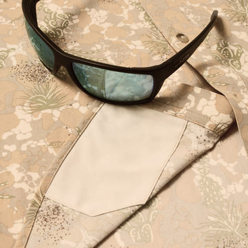 sunglasses with lens cleaner on shirt