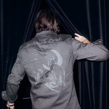 man walking in curtain wearing after dark shirt