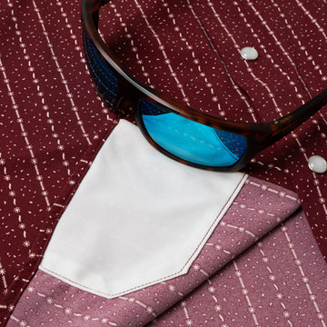 sunglasses with lens cleaner on shirt