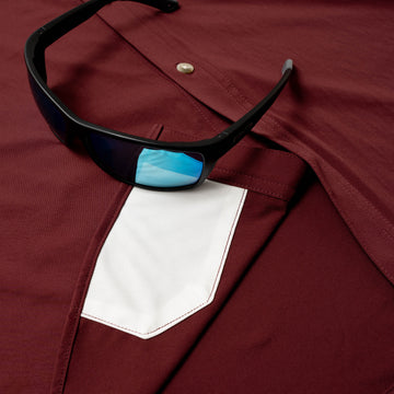 sunglasses with lens cleaner on shirt