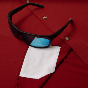 sunglasses with lens cleaner on shirt