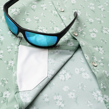 Closeup of sunglasses with lens cleaner on shirt