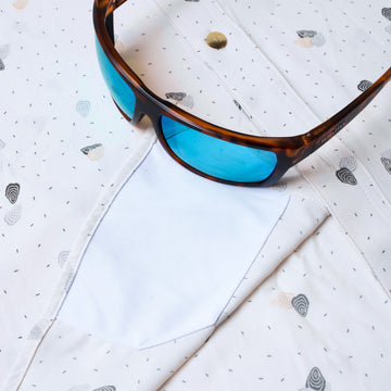 sunglasses with lens cleaner on shirt