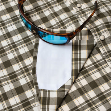Closeup of sunglasses with lens cleaner on shirt