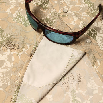 sunglasses with lens cleaner on shirt