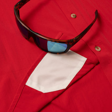 sunglasses with lens cleaner on shirt