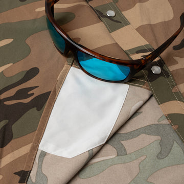 sunglasses with lens cleaner on shirt