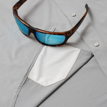 photo of grey shirt with sunglasses and lens cleaner