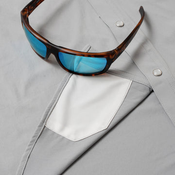 photo of grey shirt with sunglasses and lens cleaner